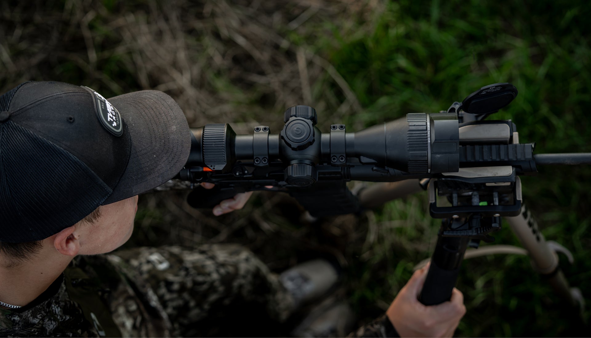 HUNTER LOOKING THROUGH THERMAL SCOPE